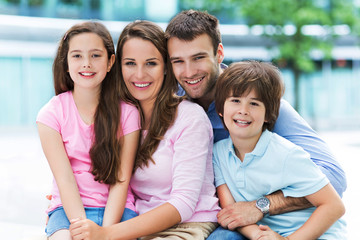 Family smiling together outdoors
