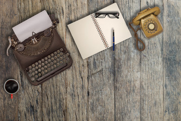 Vintage typewriter and coffee on wood background	