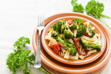Pasta with pepper and broccoli on a plate closeup