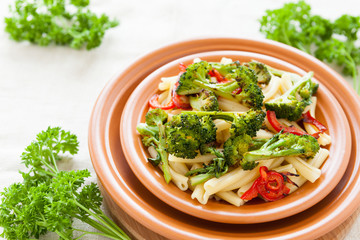 Pasta with pepper and broccoli closeup. Selective focus