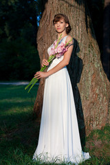 Elegant greek woman in the summer park in the morning
