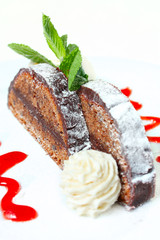 Chocolate cake with a spherule of ice cream and strawberry sauce