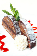 Chocolate cake with a spherule of ice cream and strawberry sauce