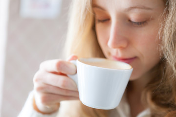 Coffee. Beautiful young woman drinking hot beverage