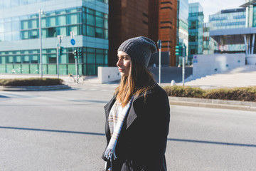 young woman outdoor walking looking away pensive - attitude, confidence, serious concept