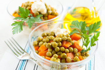 Vegetarian salad with canned peas and boiled vegetables close-up