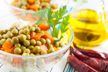 Salad with canned green peas and boiled carrots