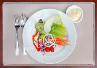 Top view fresh vegetable salad in white plate on table.