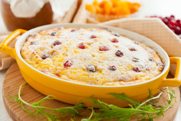 Cheese casserole with cranberries and raisins in dish