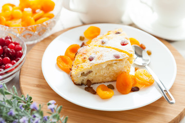 Curd pudding with dried apricot and raisins close-up on a plate