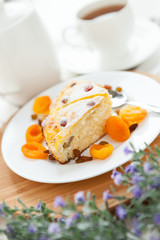 Cheese Pie with tea, dried apricot and raisins on a plate