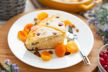 Cheese Pie closeup with dried apricot and raisins on a plate