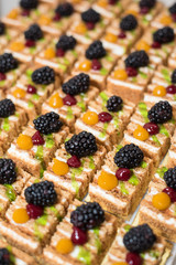 Buffet cake with blackberry. Many pieces