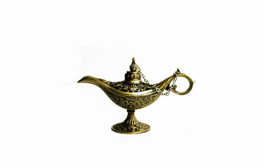 Close up of gold decorated magic lamp isolated in white background.