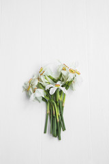 Daffodils flowers bouquet on white painted background