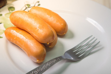  Pork sausage on wood table image closeup