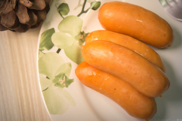  Pork sausage on wood table image closeup