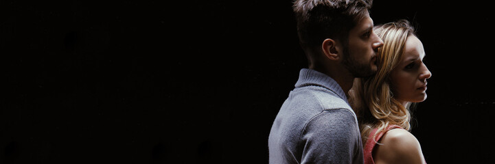 Man hugging woman from behind