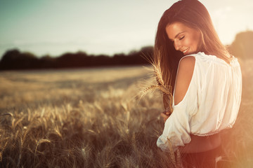 Beautiful woman in wheat meadow