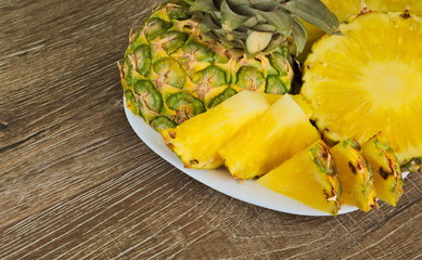 Ripe pineapple cut into slices on a plate