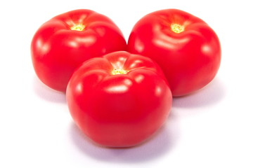 Three ripe tomatoes isolated on white background