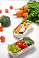Obraz na płótnie Canvas Bento box with different food, fresh veggies and fruits
