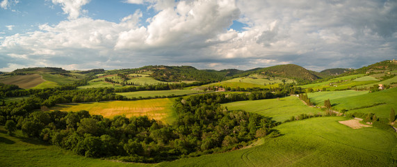 Fototapeta na wymiar Beautiful Aerial landscape of waves hills in rural nature, Tuscany farmland, Italy, Europe