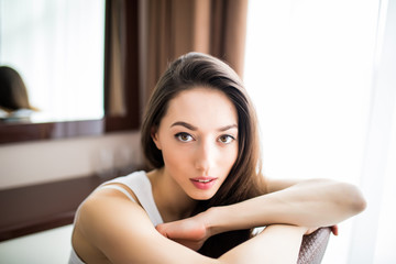 Obraz premium Relaxing woman sitting comfortable in chair smiling happy looking at camera.