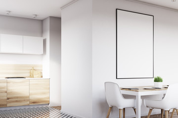 Corner of white kitchen with poster