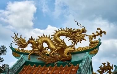 Gold dragon on a canopy. Chinese Temple