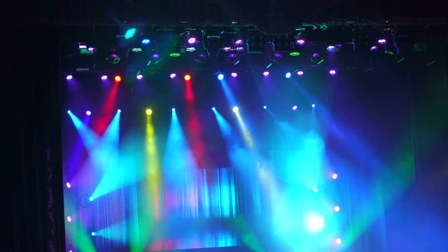 Many spotlights that illuminate the stage at a concert with fog. Entertainment concert lighting. Stage lights.