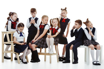 a group of school-aged children in the form of phones isolated on a white background