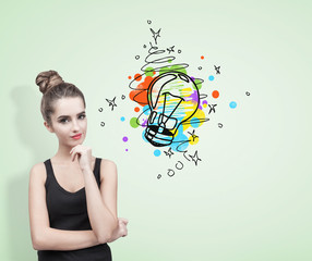 Pensive woman in a black tank top, light bulb