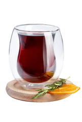 Wine in a glass is not the usual form. Wine in a glass on a wooden stand decorated with rosemary and an orange slice.