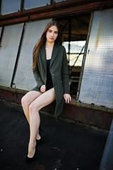 Sexy model girl wit long legs at black lingerie outfit body swimsuit combidress and jacket posed at...