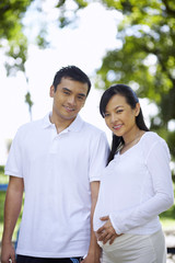 Fototapeta premium husband and pregnant wife in the park