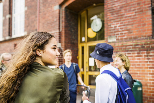 Students (14-15) talking by school