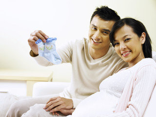 couple holding baby booties