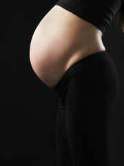 Fototapeta premium profile of pregnant woman showing her tummy