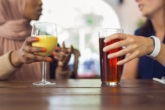 Businesswomen talking and drinking juice