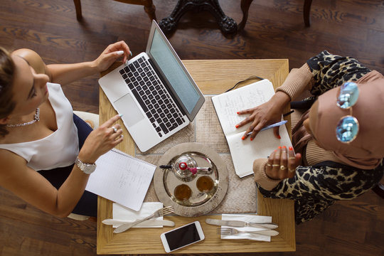 Businesswomen working in tea room