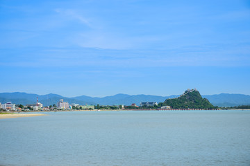 Fototapeta na wymiar Beachfront scenery with fishing boats landing at Prachuap Khiri Khan, Thailand.