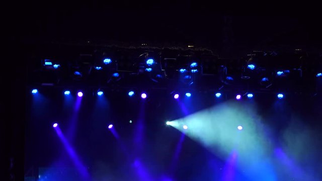 Blue and white stage lights, light show at the Concert. High resolution.