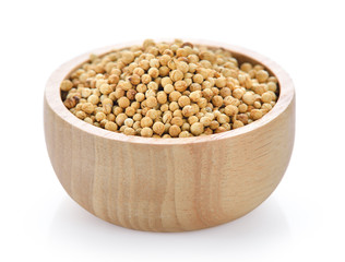 Coriander seeds in wood bowl