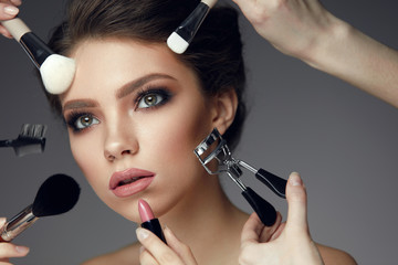 Beauty Face Makeup. Closeup Female With Cosmetic Tools Near Face