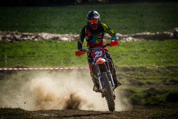 Tuinposter Motocross rider on the crosscountry race © Glasco