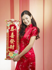 young woman holding chinese new year banner