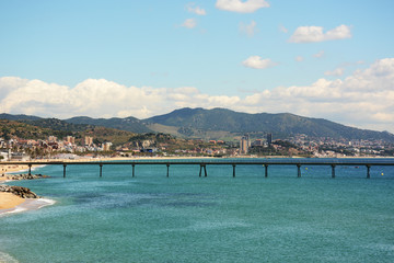 Pier on Badalona beach in Barcelona. Coast of the Mediterranean Sea