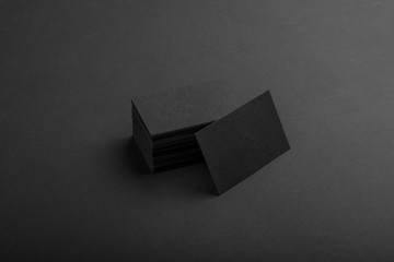 Black business cards isolated on black background