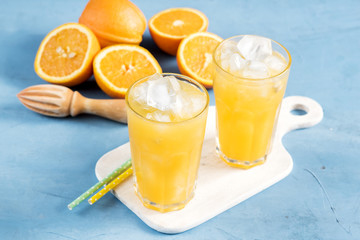 Glass of orange juice with ice cubes Cold orange fresh Glass of orange juice for hot summer day